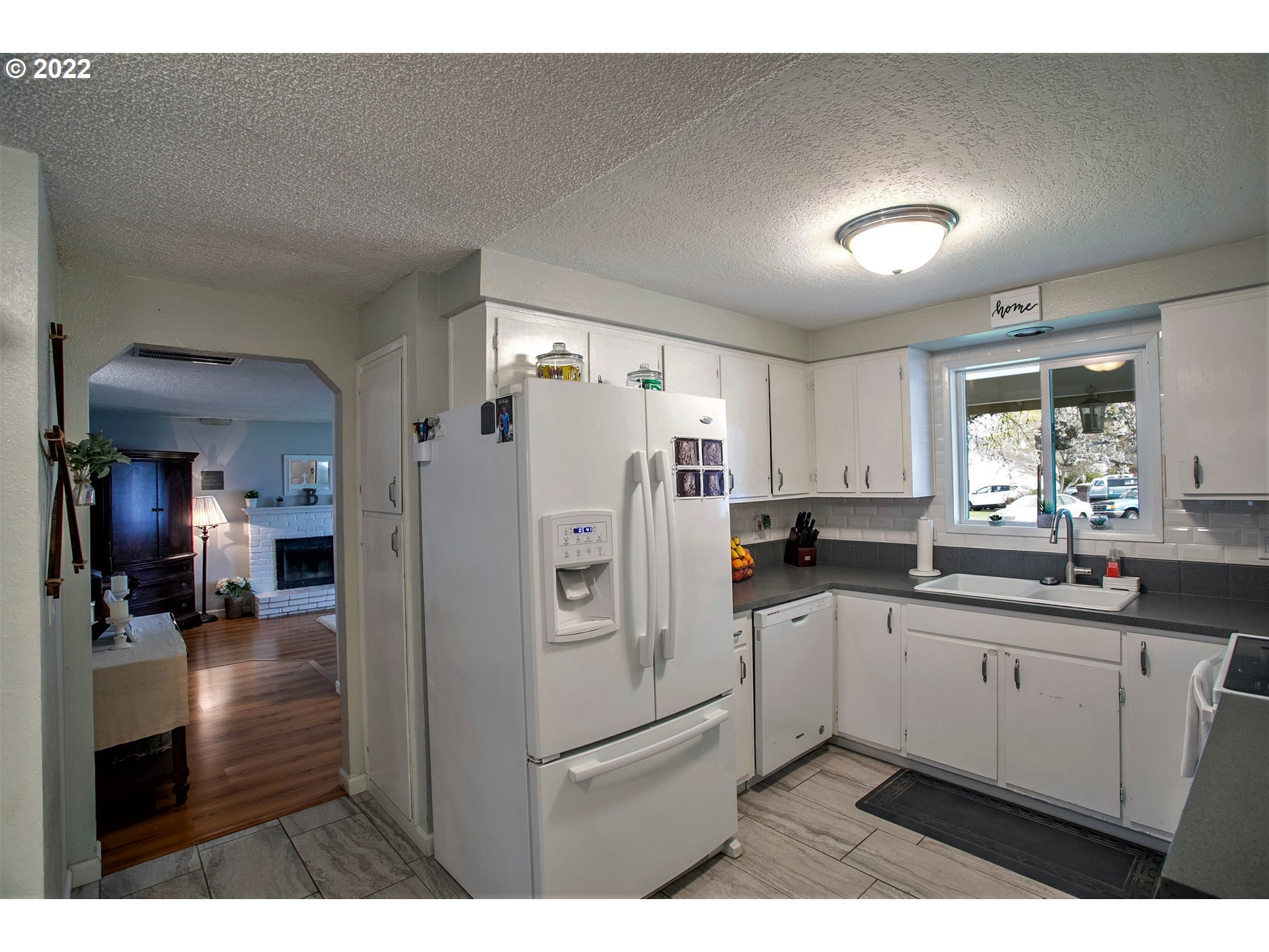6305 C Street Springfield, OR 97478 - Photo 9 of 32 a kitchen with stainless steel appliances a refrigerator sink and cabinets
