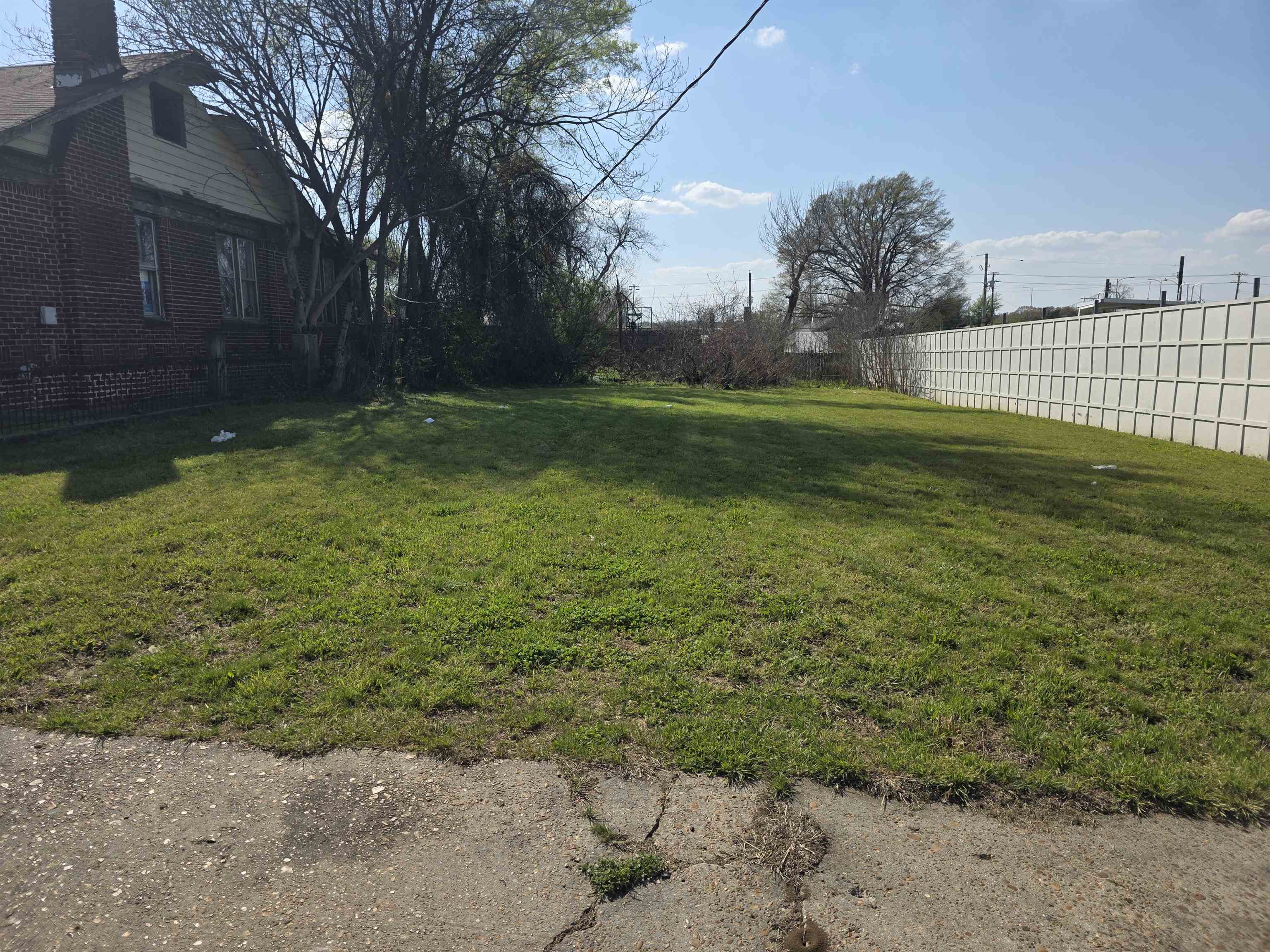 599 Lester Street Memphis, TN 38112 - Photo 15 of 15 a view of a backyard with large trees