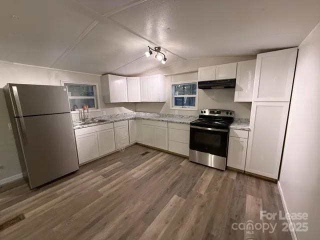 a kitchen with stainless steel appliances a refrigerator stove microwave and cabinets