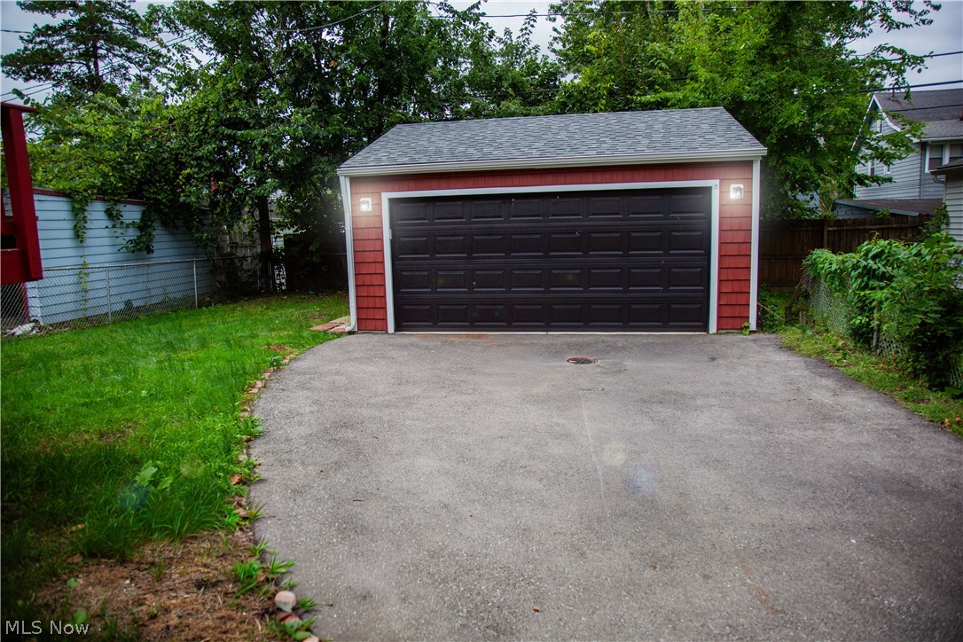 3554 Ludgate Road Shaker Heights, OH 44120 - Photo 4 of 50 Detached garage with a paneled door, red shake siding, and exterior lighting