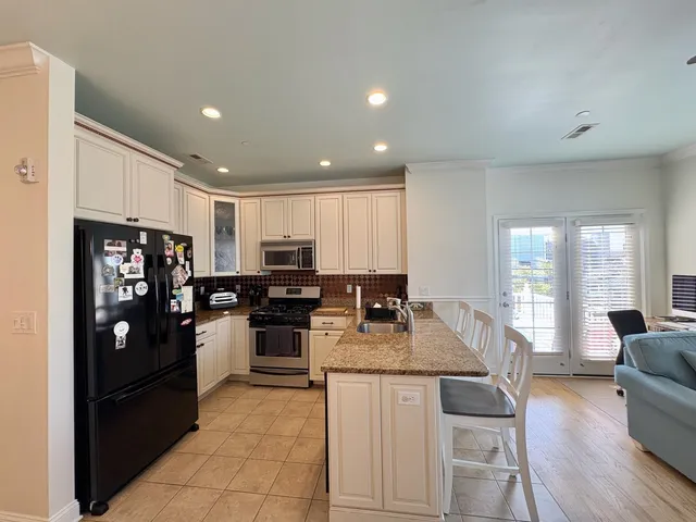 a kitchen with refrigerator and cabinets