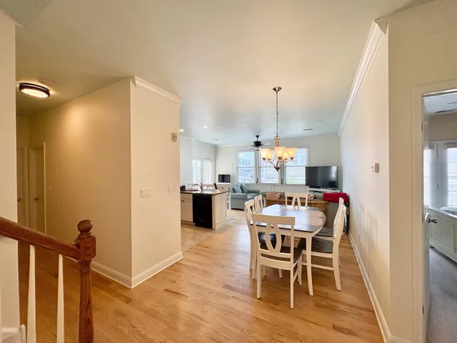 a dining room with furniture and wooden floor