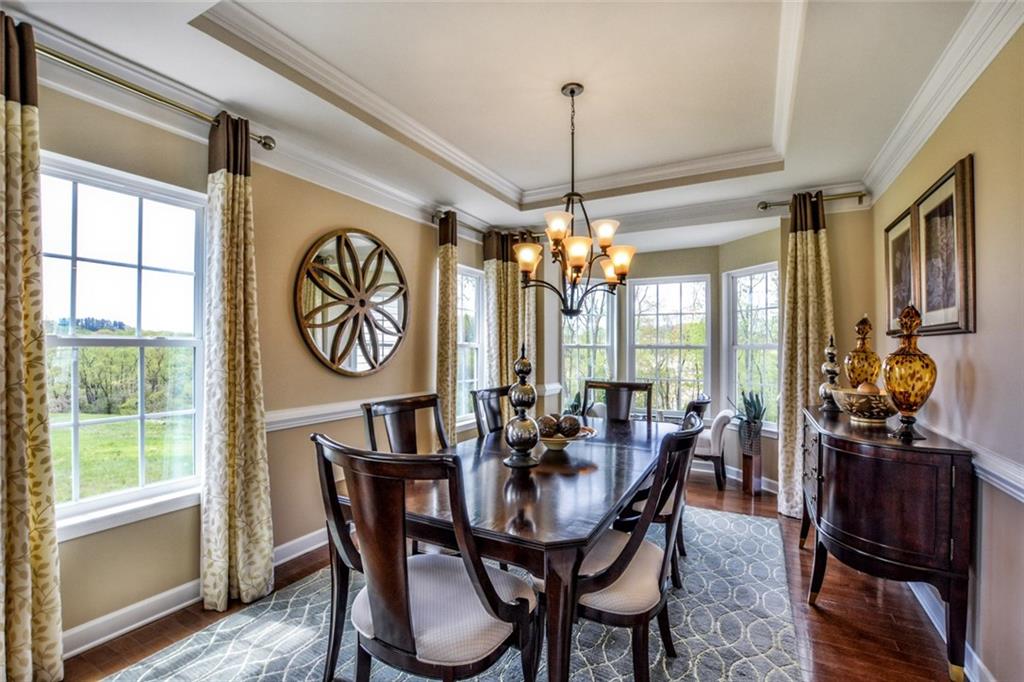 2003 Eagle Ridge Drive Valencia, PA 16059 - Photo 8 of 25 Dining Room w/Tray Ceiling, Crown Moldings, Chair Rails, Bay Window & Hardwood Flooring
