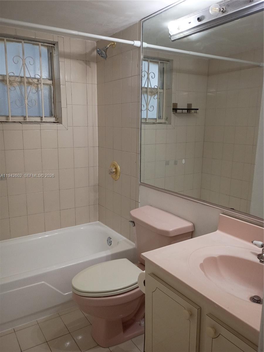 2498 Southwest 17th Avenue, Unit 4209 Miami, FL 33133 - Photo 11 of 15 a bathroom with a sink toilet and shower