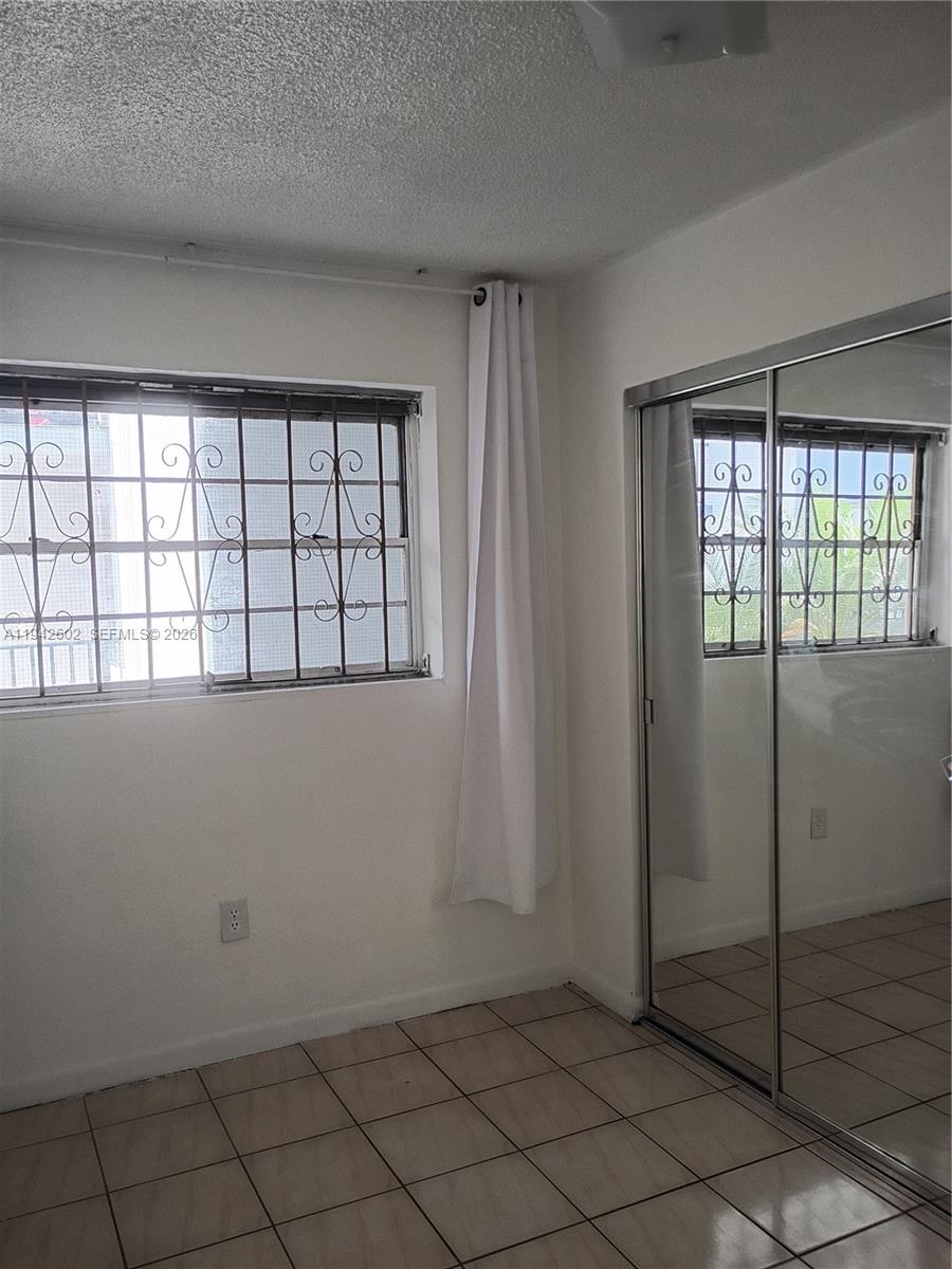 2498 Southwest 17th Avenue, Unit 4209 Miami, FL 33133 - Photo 12 of 15 an empty room with windows