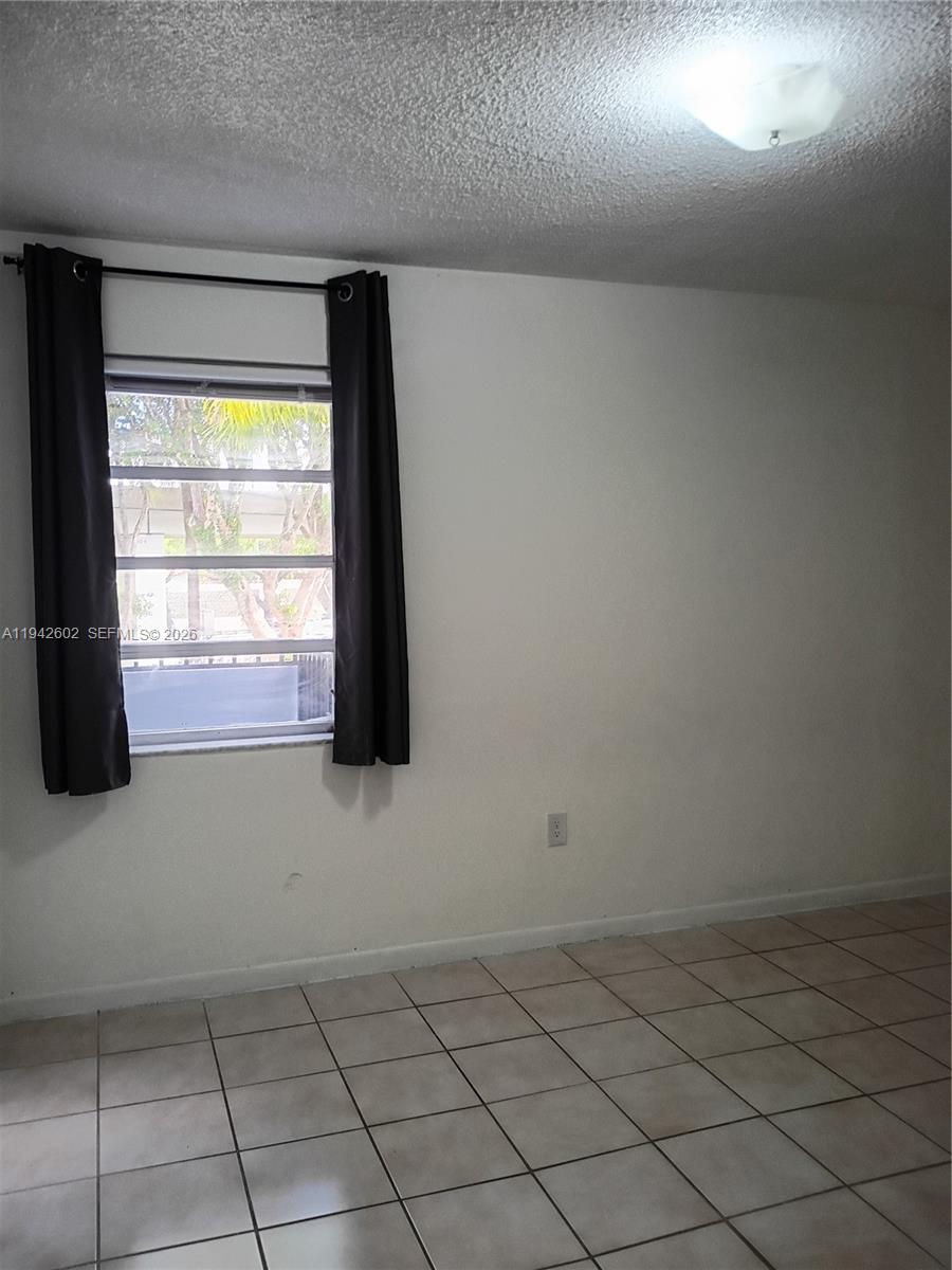 2498 Southwest 17th Avenue, Unit 4209 Miami, FL 33133 - Photo 13 of 15 a view of empty room with windows