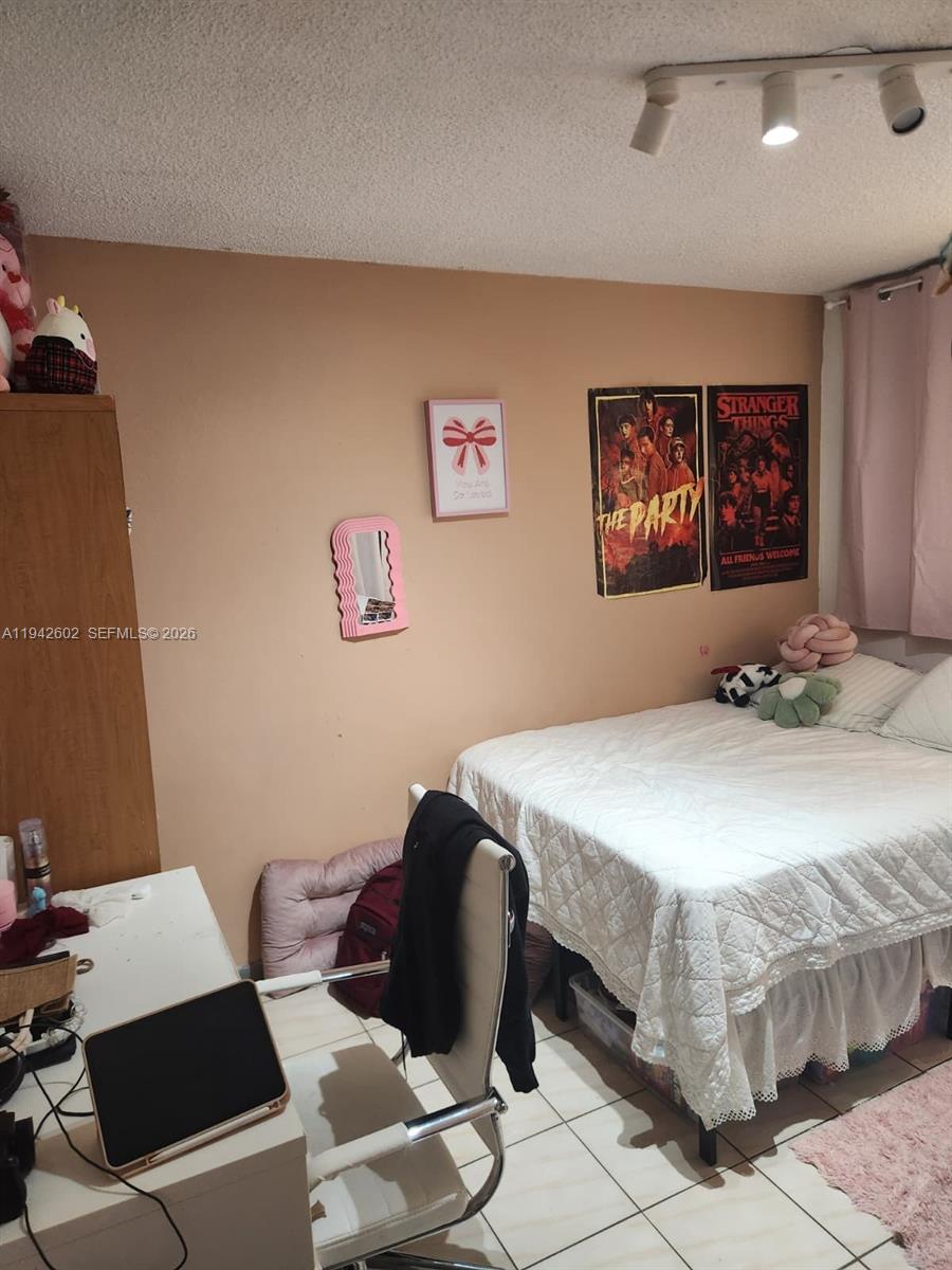 2498 Southwest 17th Avenue, Unit 4209 Miami, FL 33133 - Photo 3 of 7 a bedroom with a bed and a table