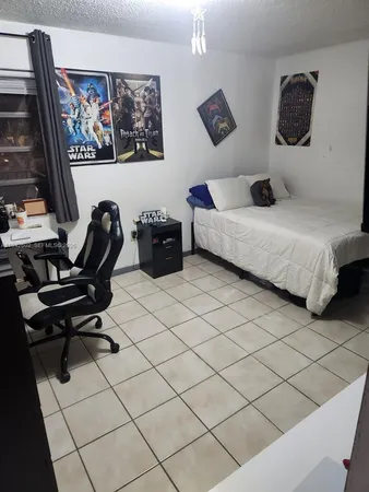 a bedroom with a bed and a desk