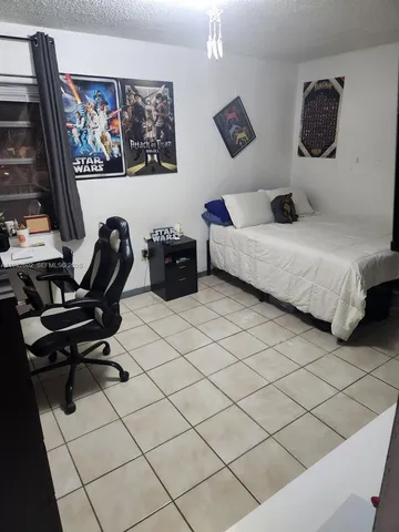 a bedroom with a bed and a desk