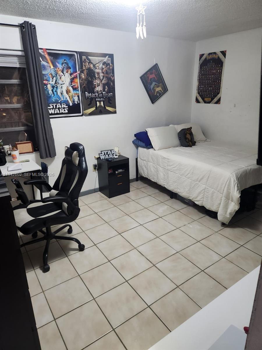 2498 Southwest 17th Avenue, Unit 4209 Miami, FL 33133 - Photo 4 of 7 a bedroom with a bed and a desk