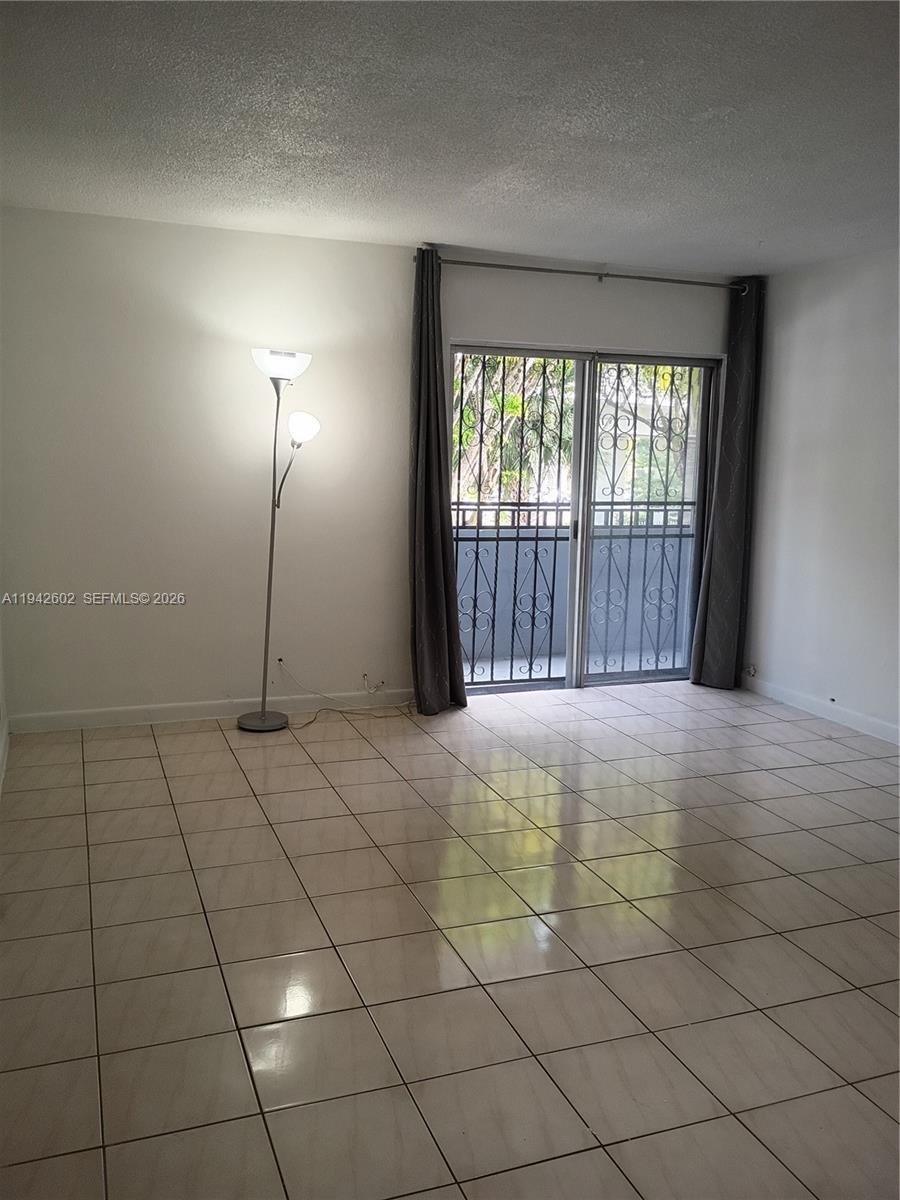 2498 Southwest 17th Avenue, Unit 4209 Miami, FL 33133 - Photo 9 of 15 a view of an empty room and a window