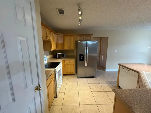 a kitchen with stainless steel appliances a refrigerator and a sink