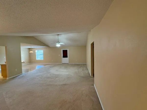 a view of a big room with closet and windows