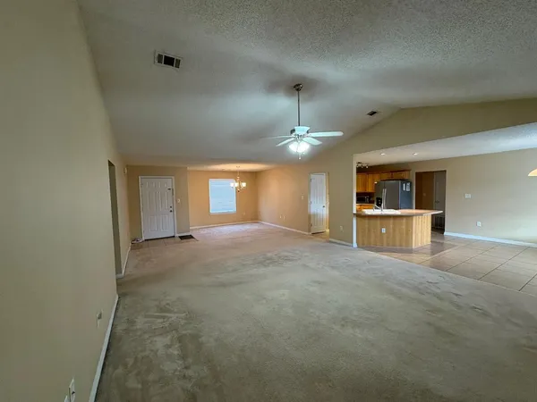 a view of a kitchen with a sink and a refrigerator