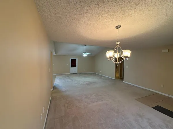 a view of a chandelier in big room and chandelier fan