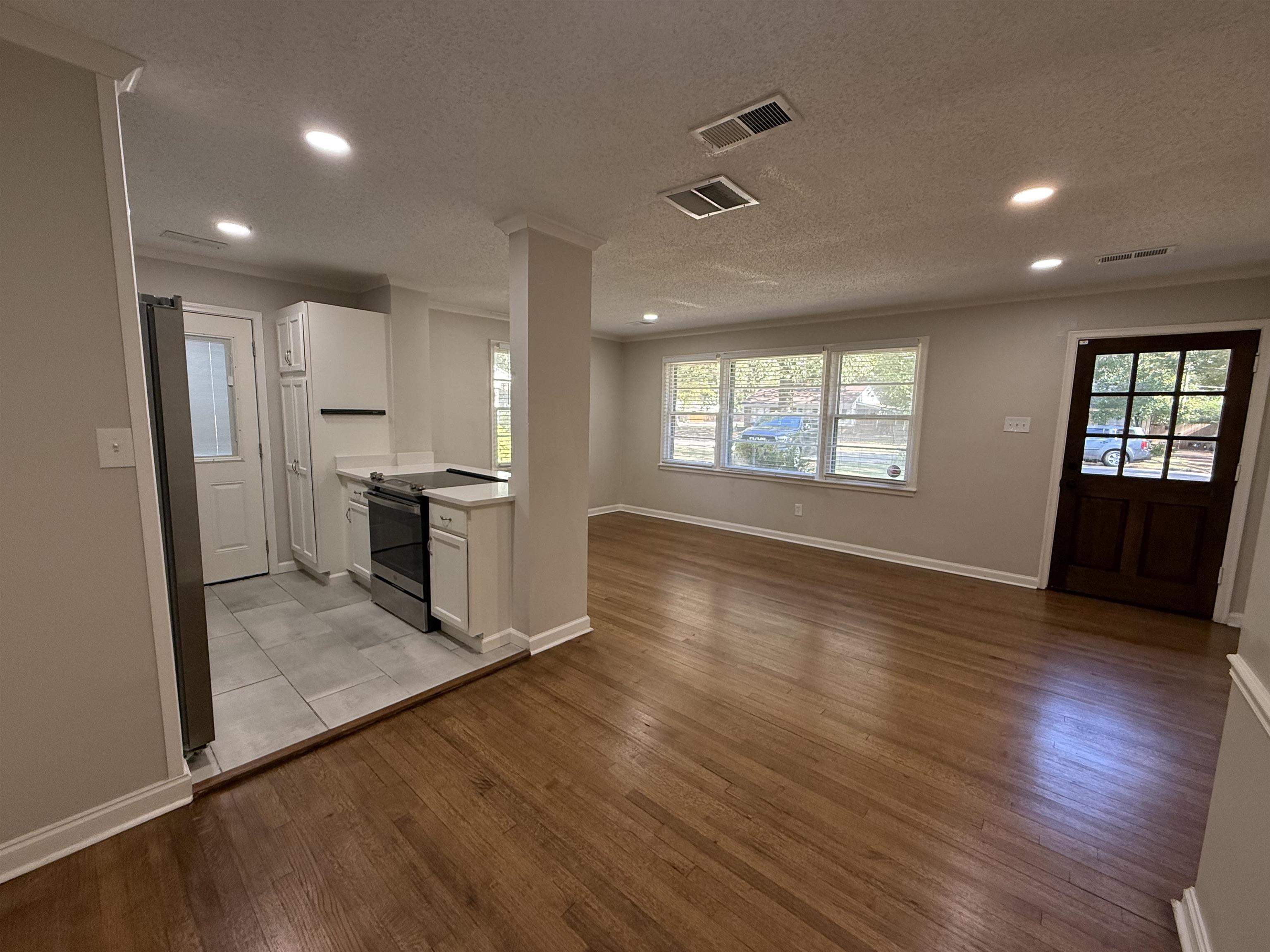 1409 Dearing Road Memphis, TN 38117 - Photo 9 of 9 an empty room with wooden floor and windows