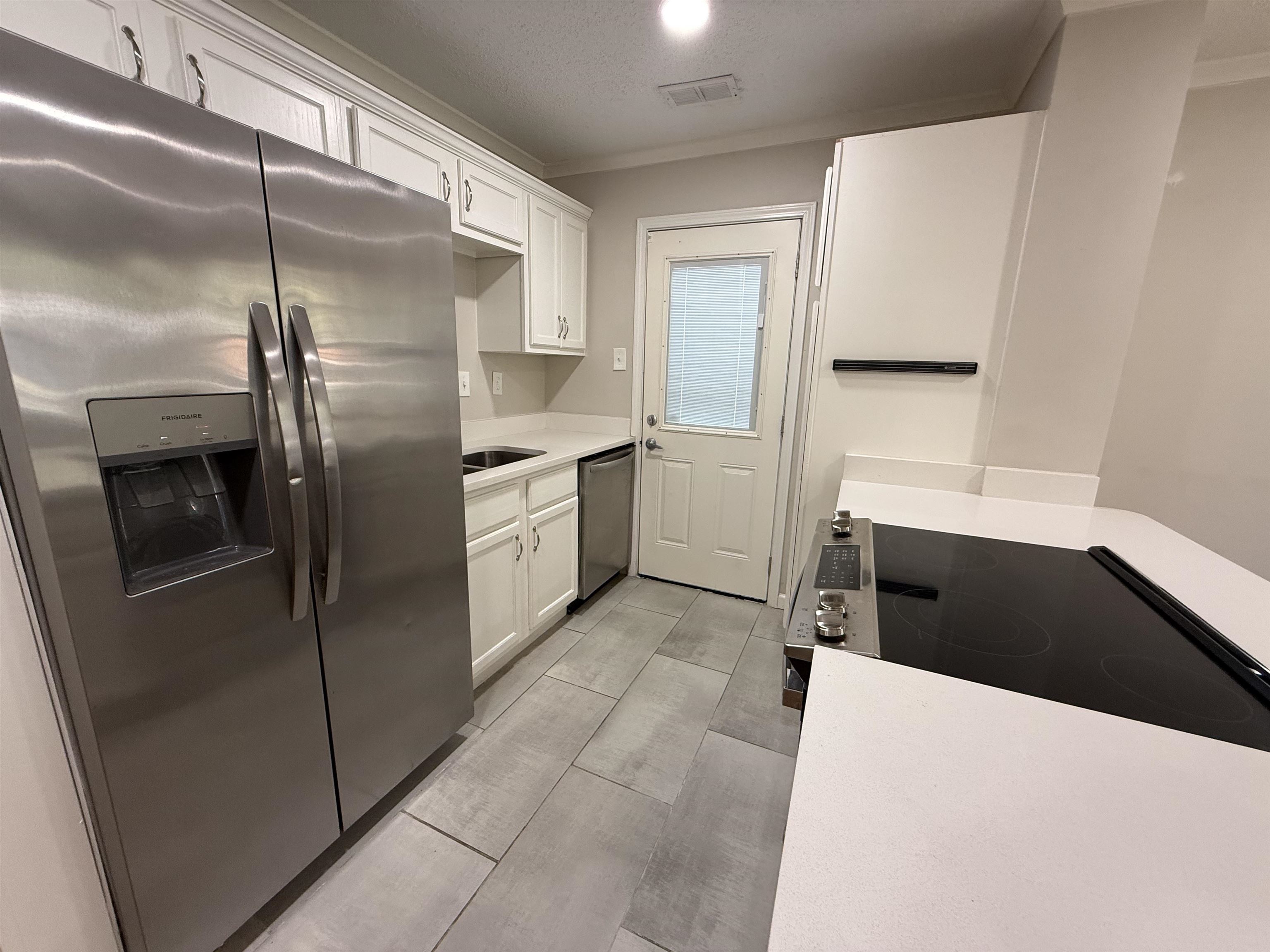 1409 Dearing Road Memphis, TN 38117 - Photo 3 of 9 a kitchen with stainless steel appliances granite countertop a refrigerator and a sink