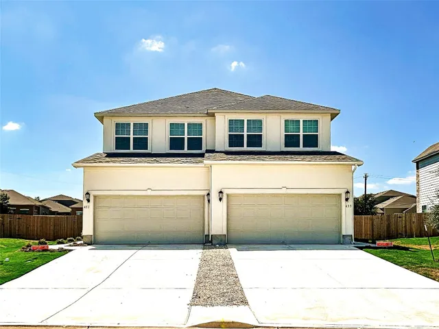 a front view of a house with a garage