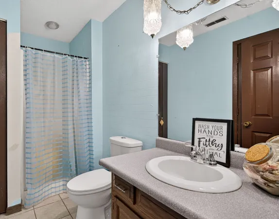 a bathroom with a sink vanity tub and shower