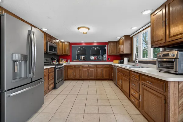 a kitchen with stainless steel appliances granite countertop a refrigerator sink and microwave