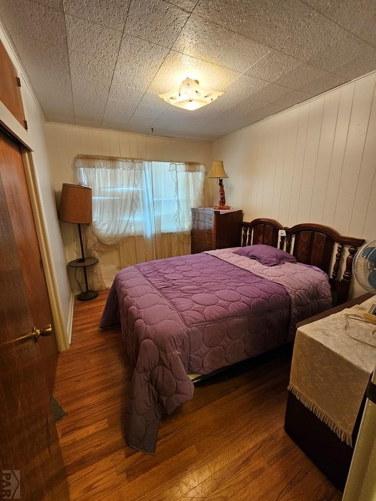 900 Rittgers Street Eads, CO 81036 - Photo 11 of 31 a bedroom with a bed and wooden floor