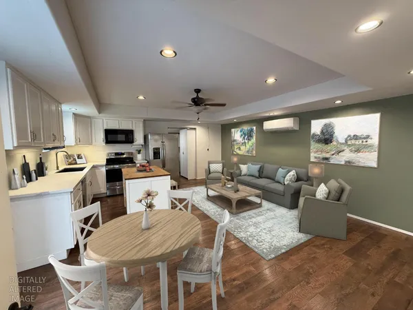 a living room with lots of furniture and kitchen view