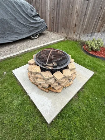 a view of a backyard with plants and outdoor seating