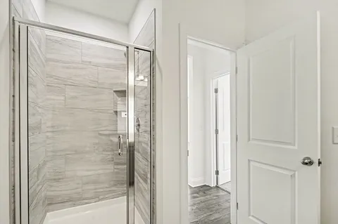 a bathroom with a glass shower door