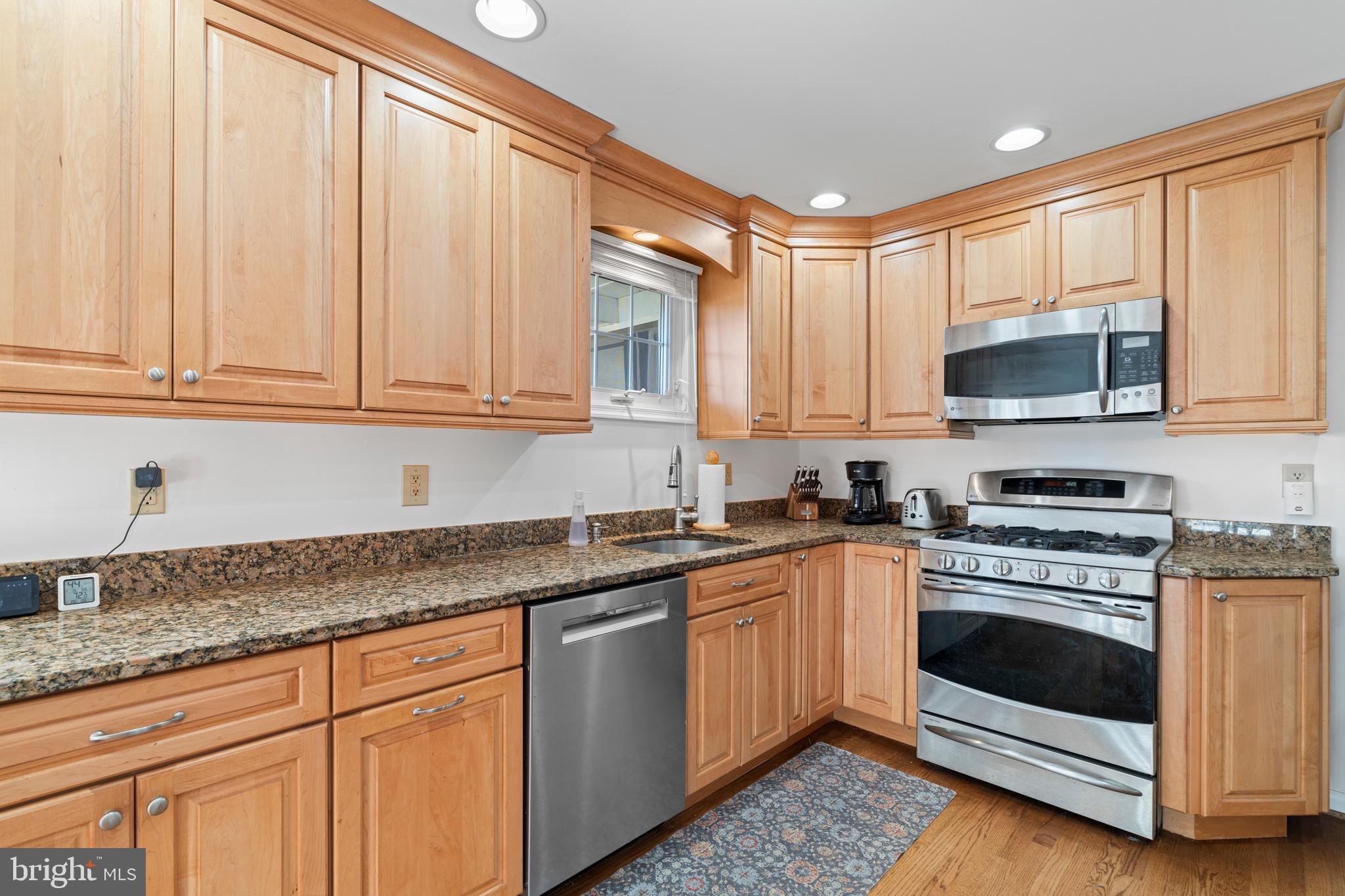 128 North Lynbrook Road Bel Air, MD 21014 - Photo 28 of 48 a kitchen with granite countertop white cabinets and white appliances