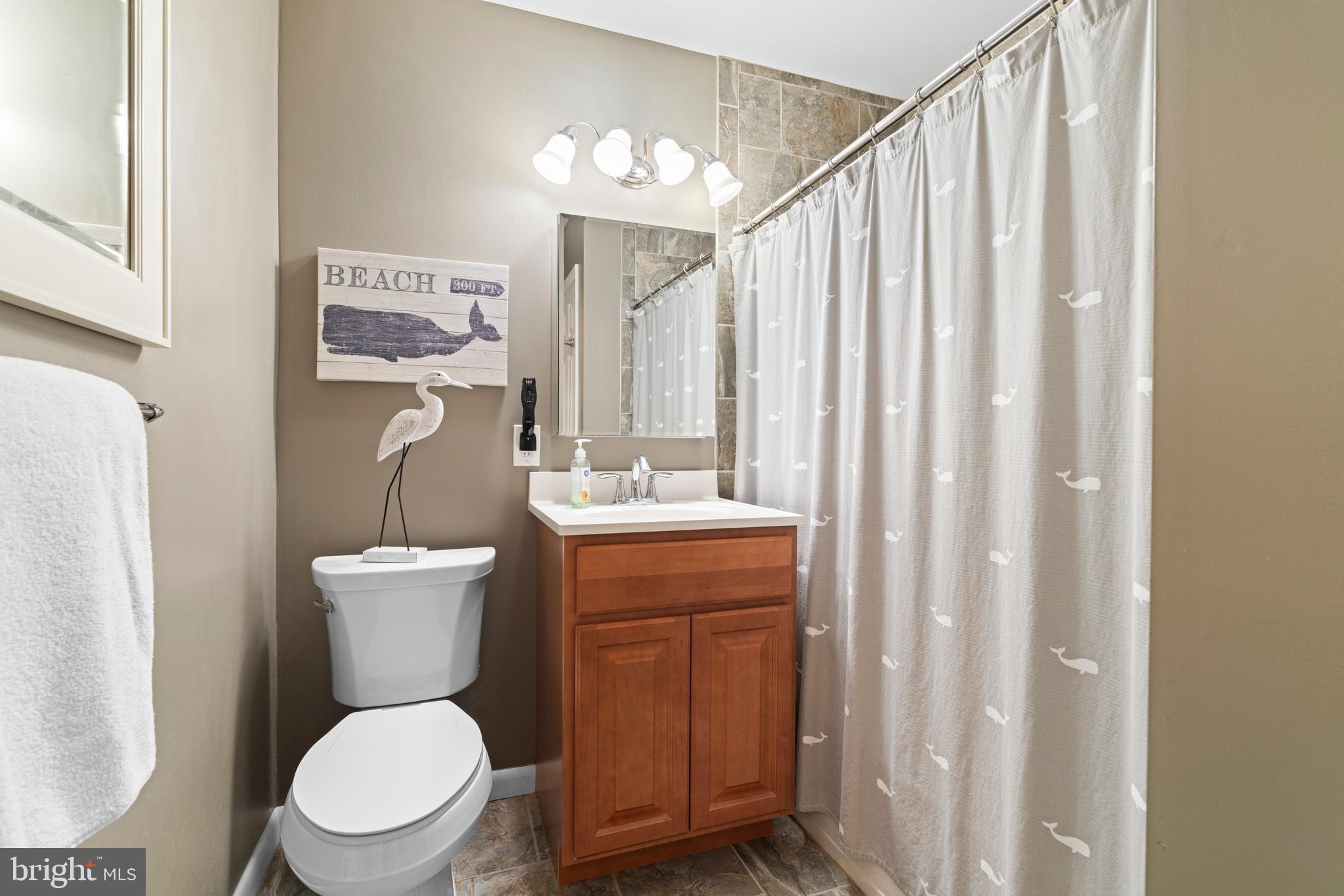 128 North Lynbrook Road Bel Air, MD 21014 - Photo 33 of 48 a bathroom with a toilet a sink and a shower curtain