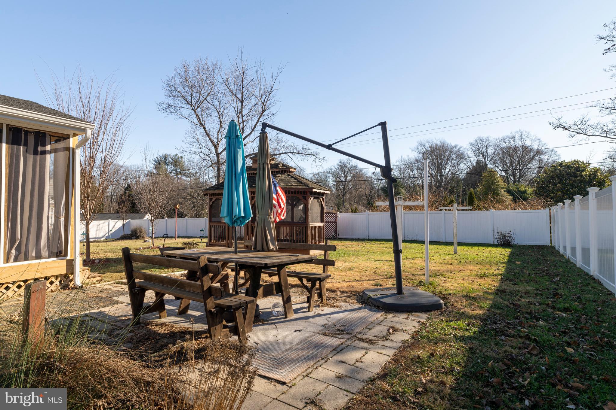 128 North Lynbrook Road Bel Air, MD 21014 - Photo 47 of 48 a view of a patio with table and chairs potted plants with wooden floor and fence