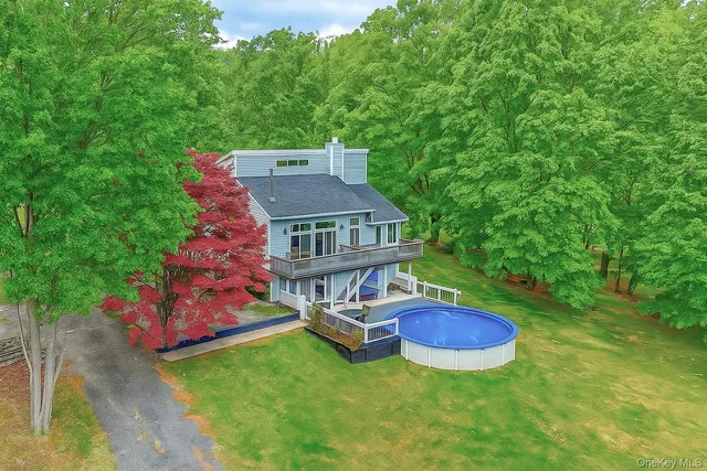an aerial view of a house with swimming pool garden and patio
