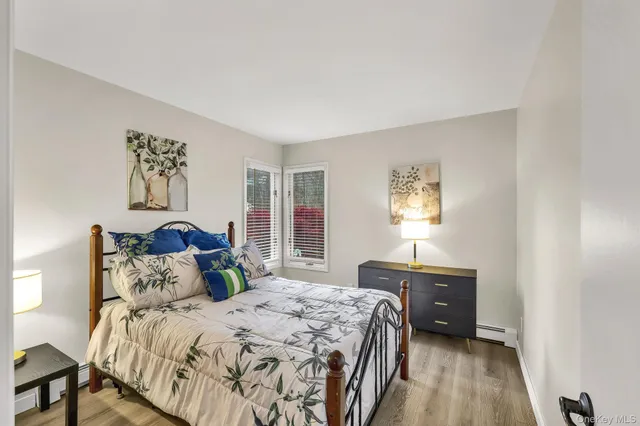 a bathroom with a granite countertop sink toilet and a mirror