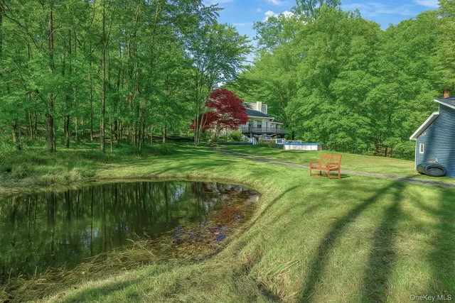 a backyard of a house with a yard and outdoor seating