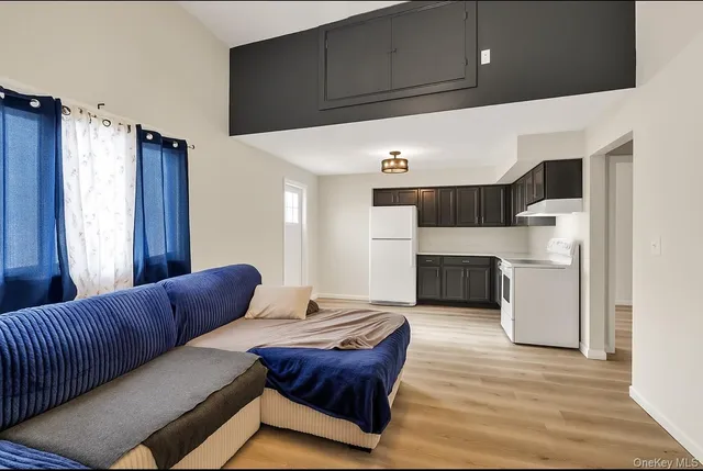 a living room with couches and painted walls with wooden floor