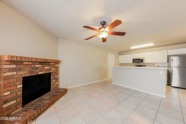 a view of a kitchen with an empty space and a fireplace