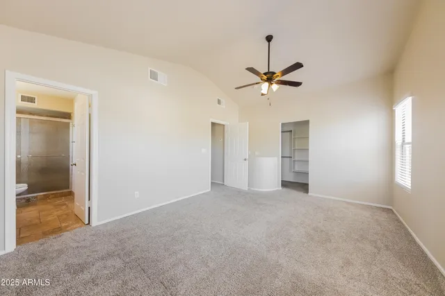 a view of an empty room with a ceiling fan