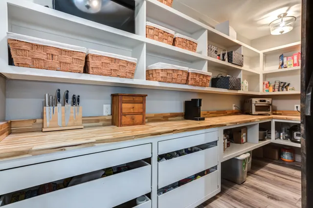 a view of an empty room and wooden floor