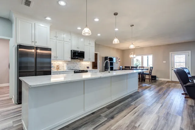a kitchen with a refrigerator and cabinets