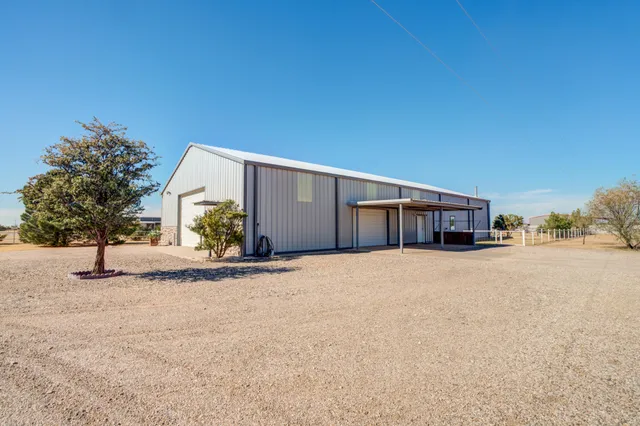 a view of a house with a yard and garage