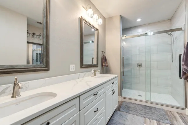 a spacious bedroom with a bed and a chandelier