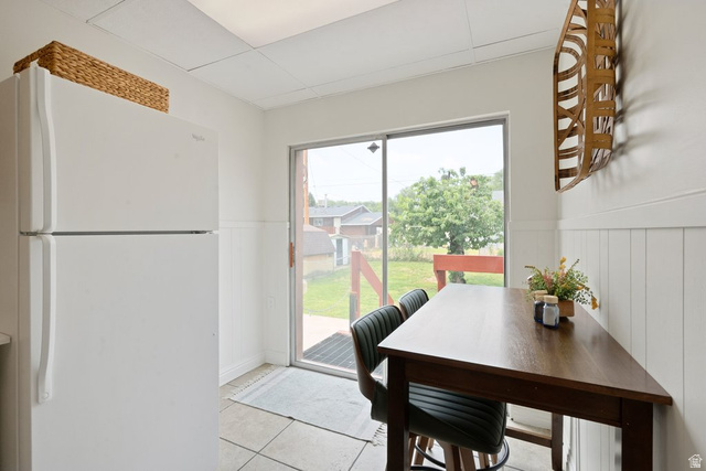 673 East 700 South Springville, UT 84663 - Photo 15 of 43 Kitchen area featuring a built-in refrigerator, white wall paneling, tile flooring, and a sliding glass door providing exterior access