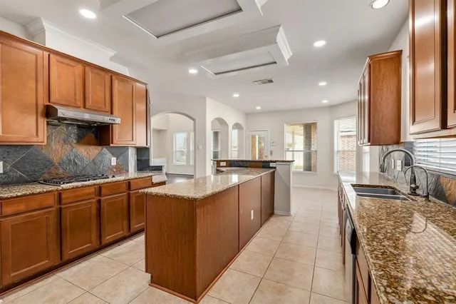 a large kitchen with stainless steel appliances lots of counter top space