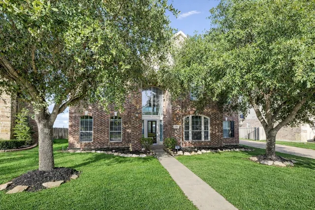 front view of a house with a tree in a yard