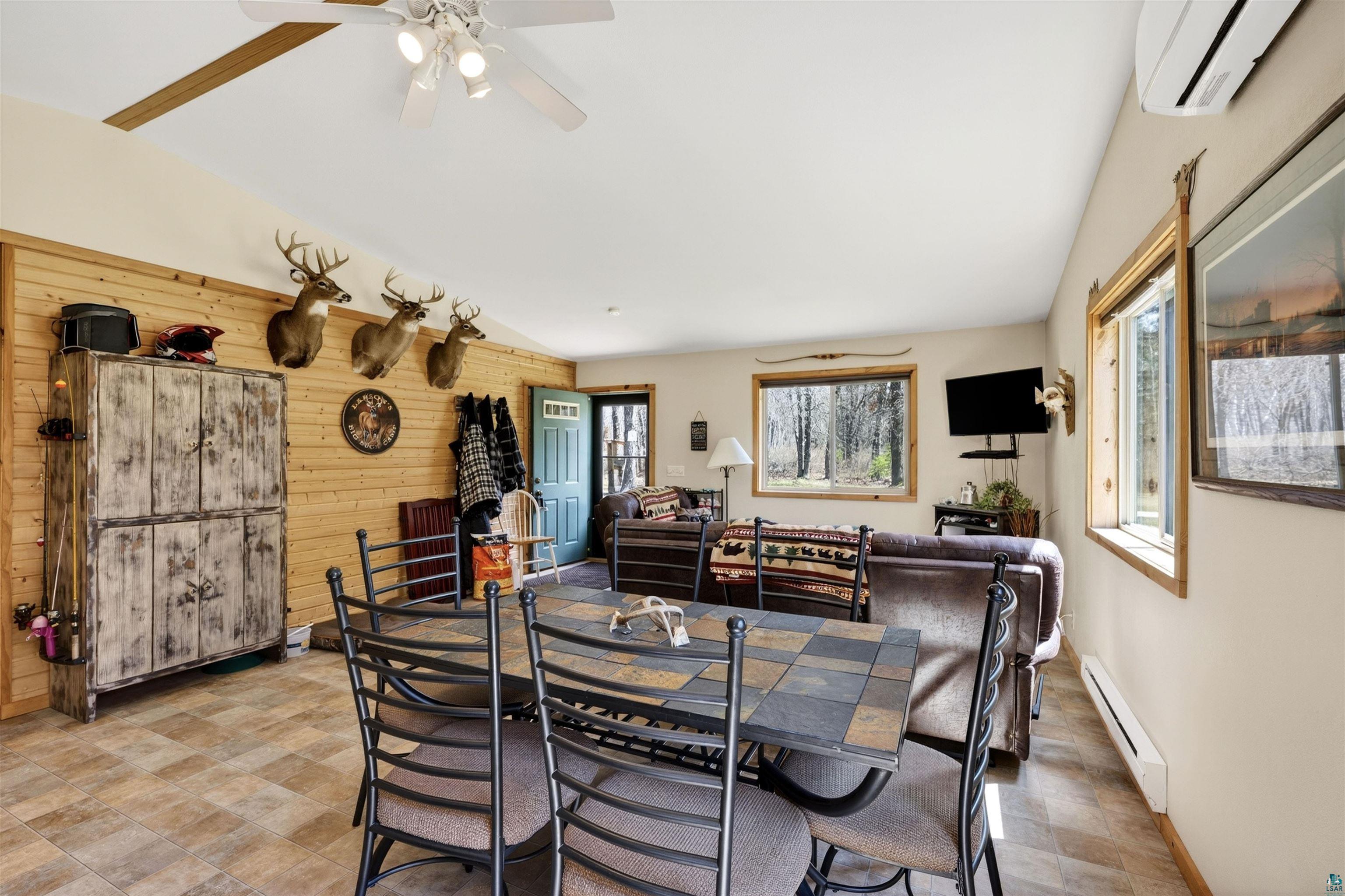 12235 East Crooked Lake Road Gordon, WI 54838 - Photo 15 of 48 Spacious open-concept room featuring light wood-finish flooring and a wood plank accent wall