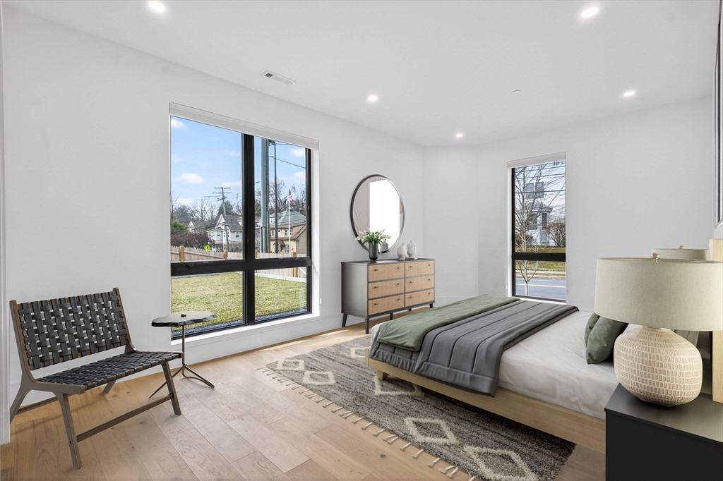 1114 Beacon Street, Unit 101 Newton, MA 02461 - Photo 12 of 29 a bedroom with a bed and a large window