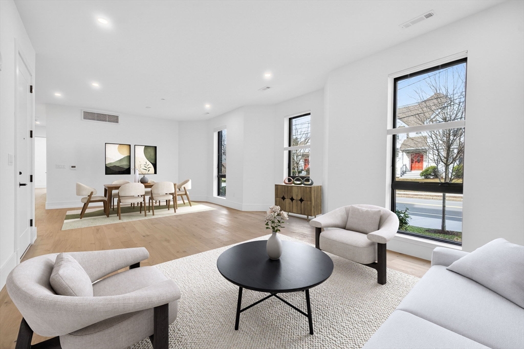 1114 Beacon Street, Unit 101 Newton, MA 02461 - Photo 2 of 29 a living room with furniture and a flat screen tv