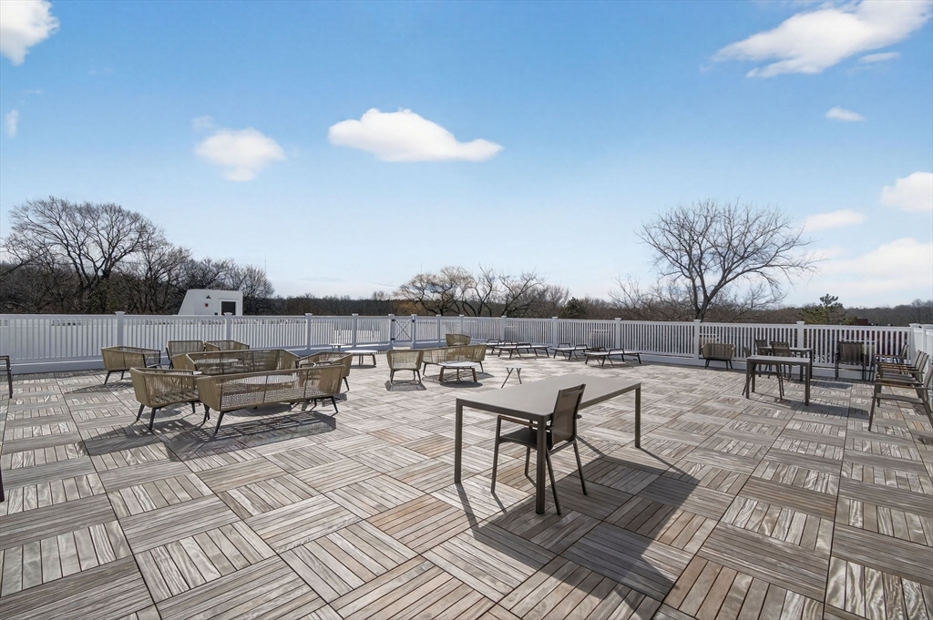 1114 Beacon Street, Unit 101 Newton, MA 02461 - Photo 22 of 29 a roof deck view with table and chairs