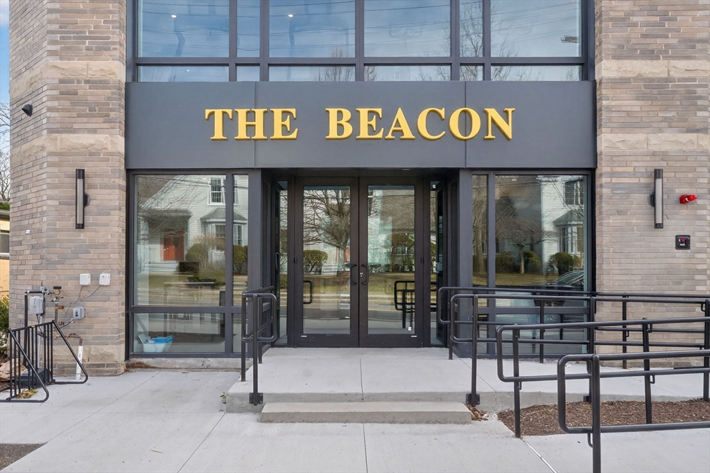 1114 Beacon Street, Unit 101 Newton, MA 02461 - Photo 24 of 29 a view of a brick building with a sign on the wall