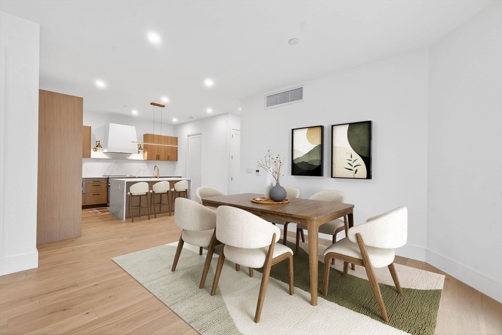 1114 Beacon Street, Unit 101 Newton, MA 02461 - Photo 3 of 29 a view of a dining room with furniture and wooden floor